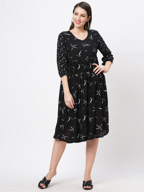 Featuring A Wide Black Dress With Gathers And Sleeves In Complimenting Print