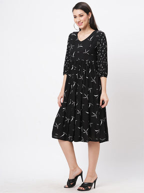 Featuring A Wide Black Dress With Gathers And Sleeves In Complimenting Print